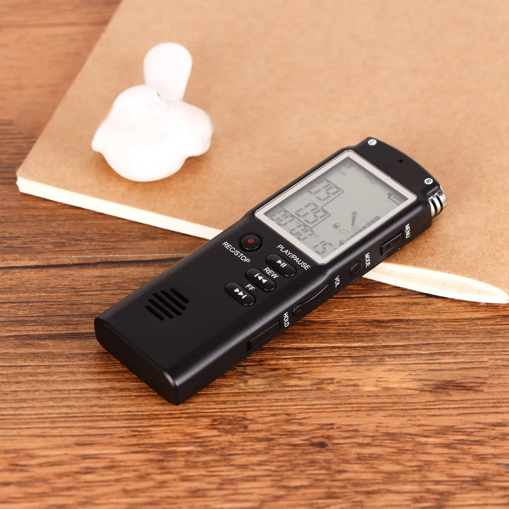 Compact USB digital voice recorder with external microphone on a desk.