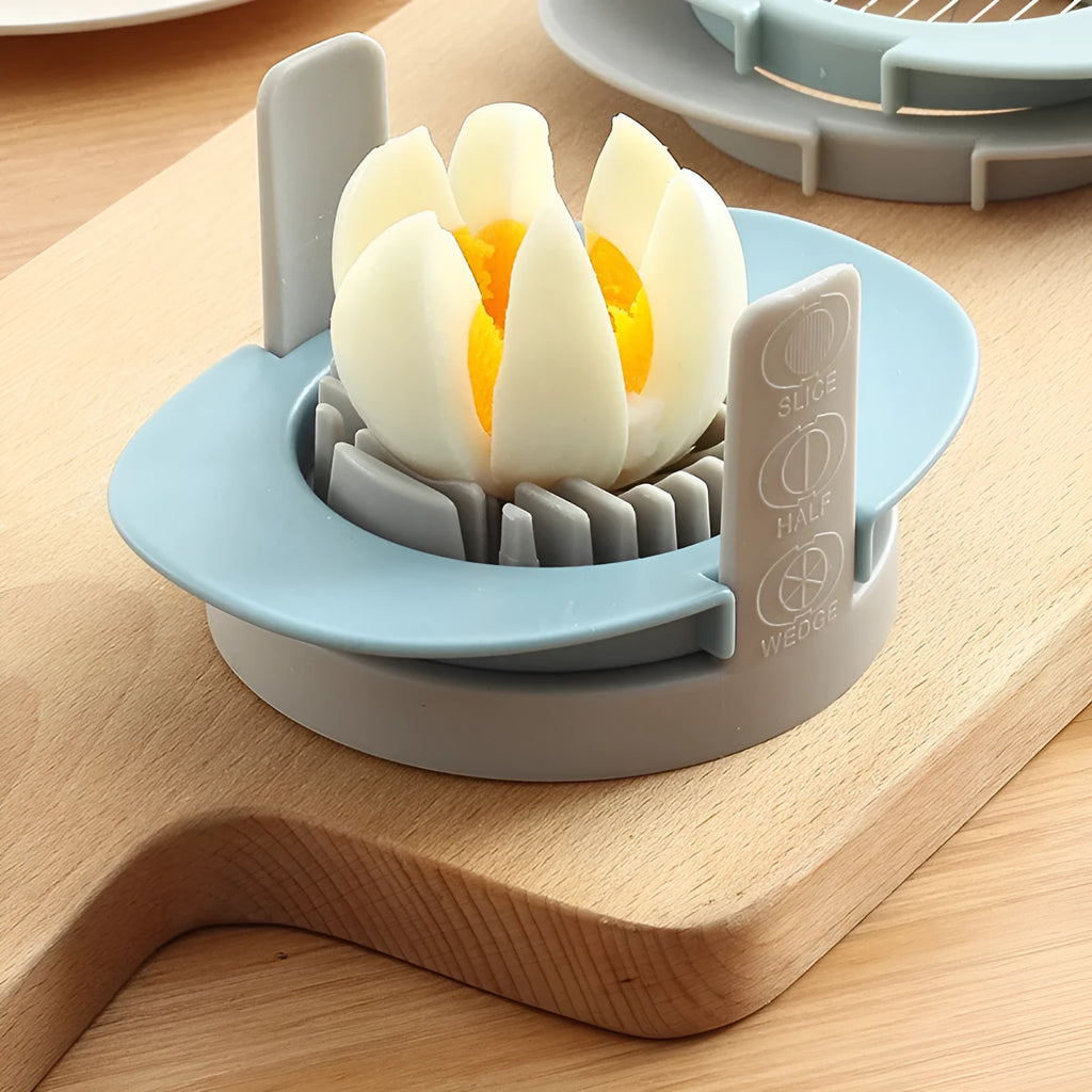 Manual three-in-one egg cutter in blue, orange and red with stainless steel blades and stackable design