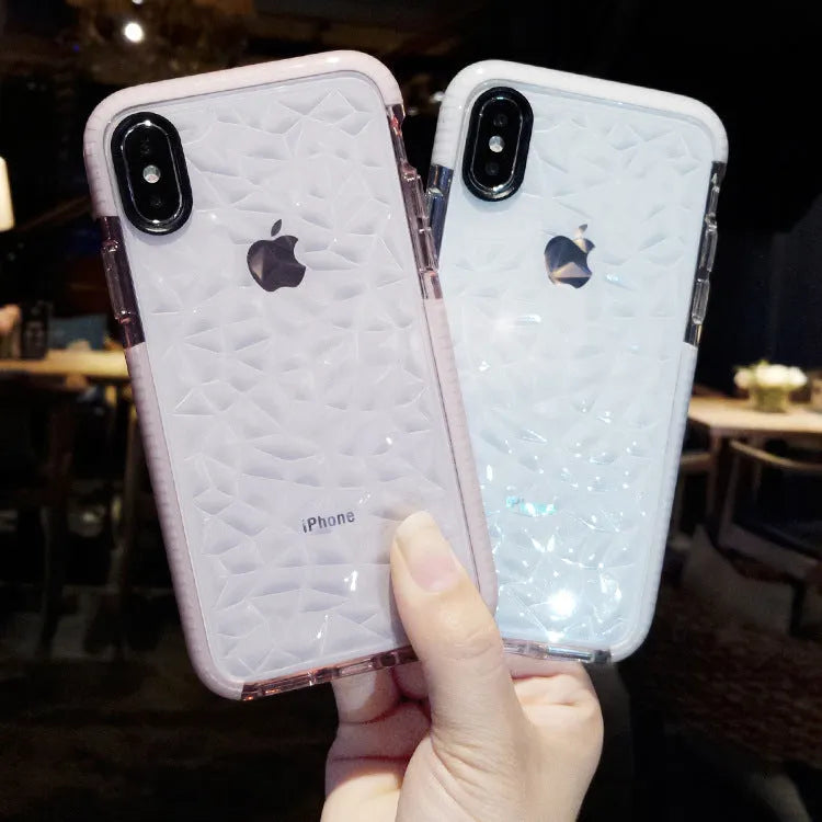 Striped TPU iPhone case shown in black, pink, and white edge colour options on a table.
