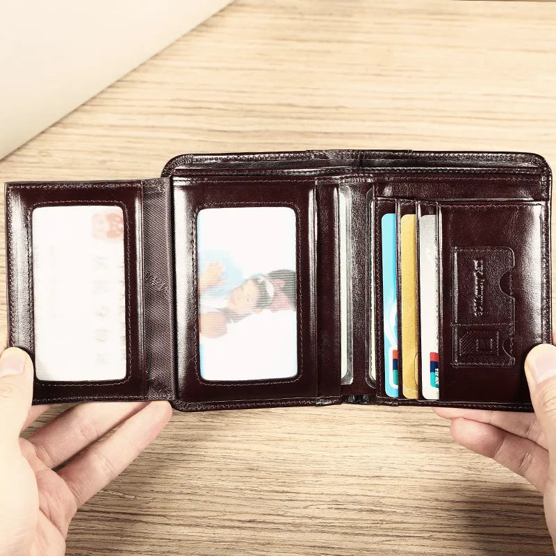 Men's black full-grain leather bifold wallet open, showing eight card slots and a zipped coin pocket.