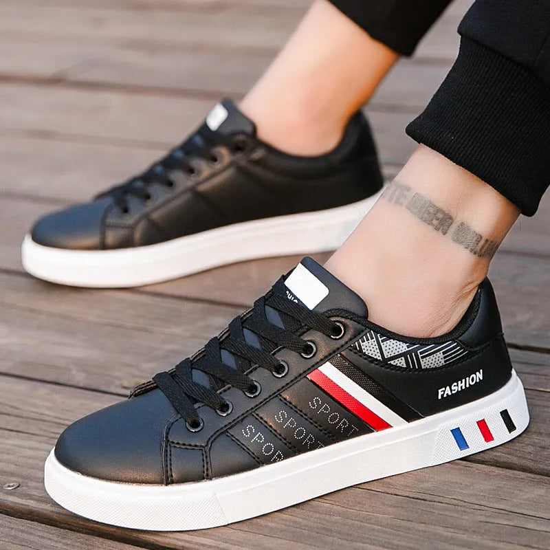 Classic black, gray and white mesh sports shoes with a cushioned midsole, shown from a side angle.