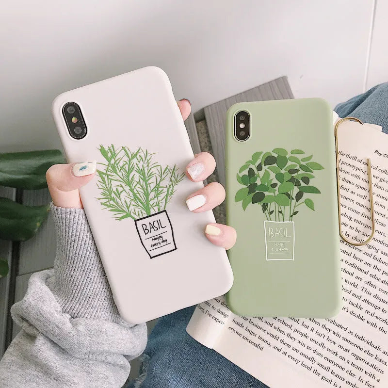 White silicone iPhone case with a detailed painted plant pattern on the back, showing its 360-degree protective edges.