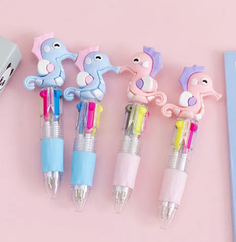 Cartoon-themed four colour press ballpoint pen with plastic and silicone body on a white background.