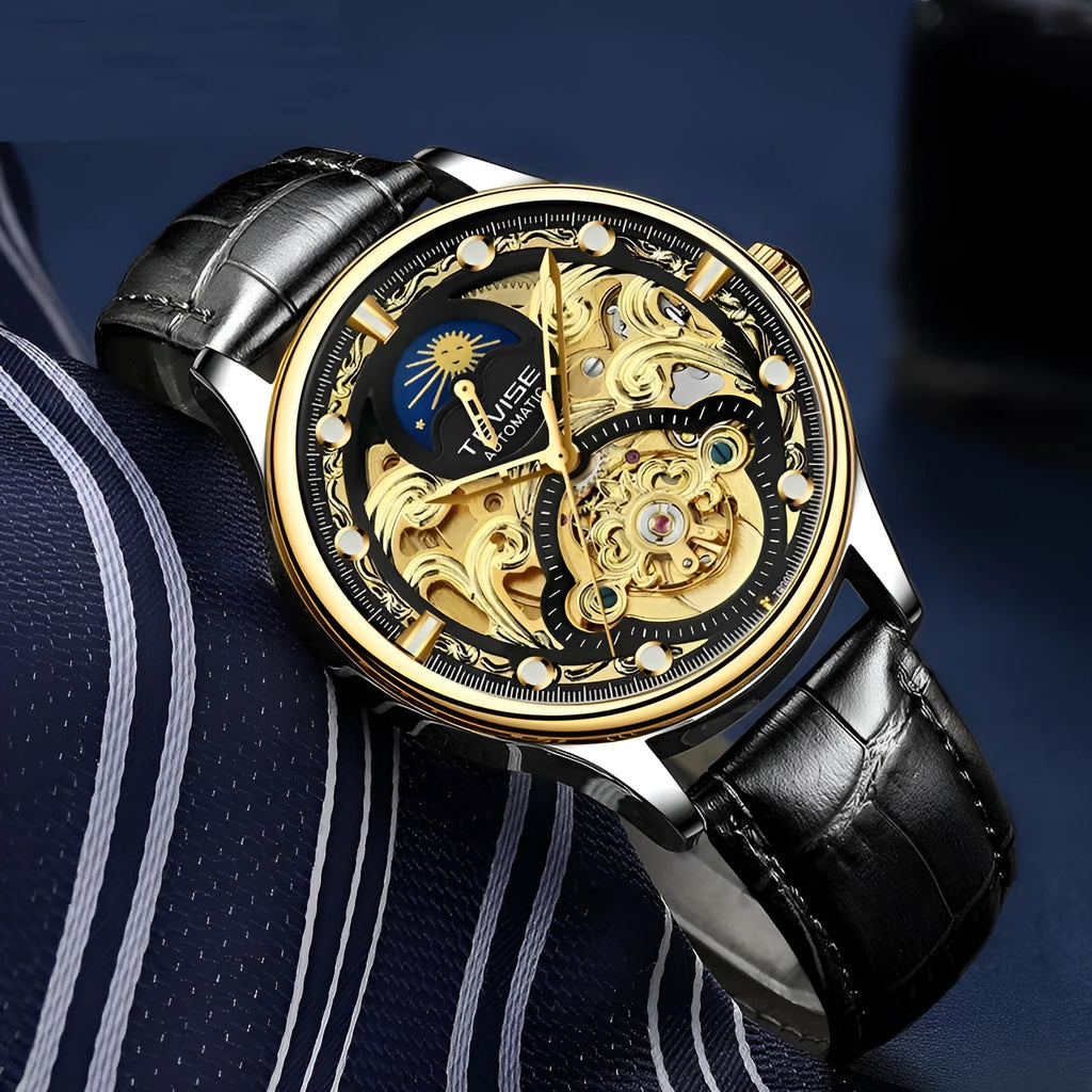 Men's gold leather strap automatic mechanical watch with analogue dial on wrist.