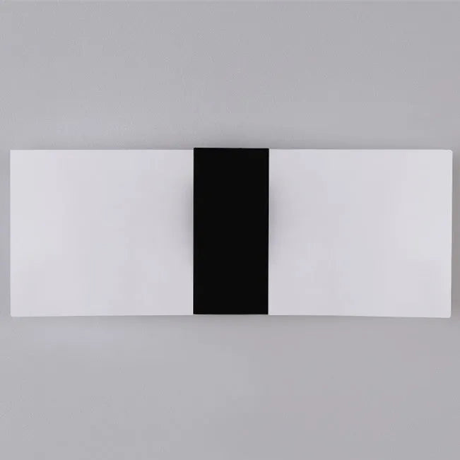 Black acrylic LED wall lamp mounted on a wall, measuring 27cm by 10cm.