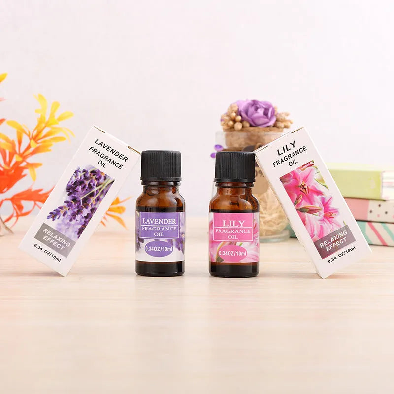 Set of 12 small glass bottles of aromatherapy essential oil, 10ml each, with labels showing Lavender, Rose, Lemon, and other fragrances.