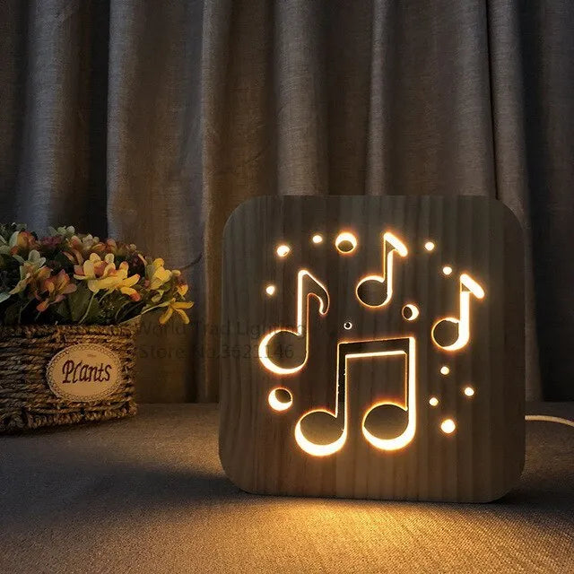 Wooden cube LED atmosphere lamp with warm white light on a desk, showing USB cable.
