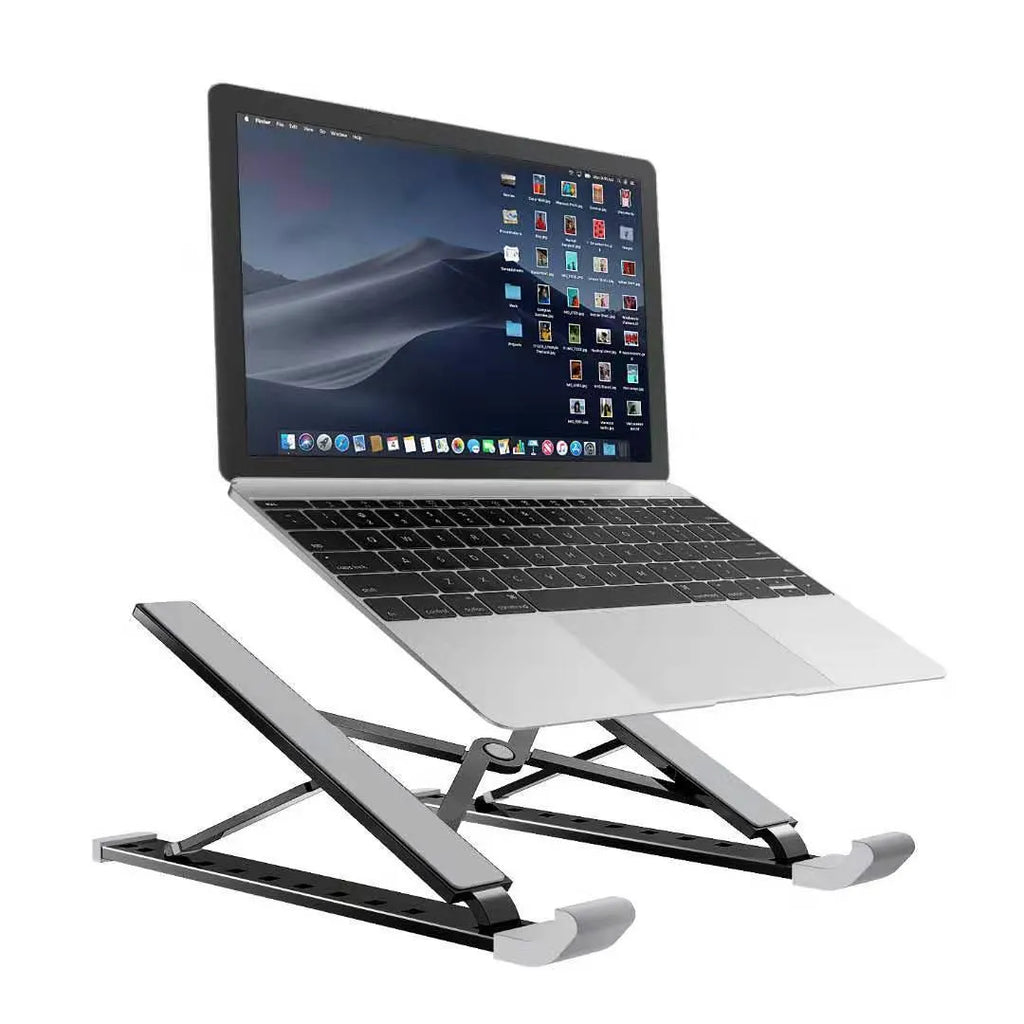 Folding laptop stand in silver with adjustable angle, holding a laptop, showing hollow bottom and non-slip silicone pads
