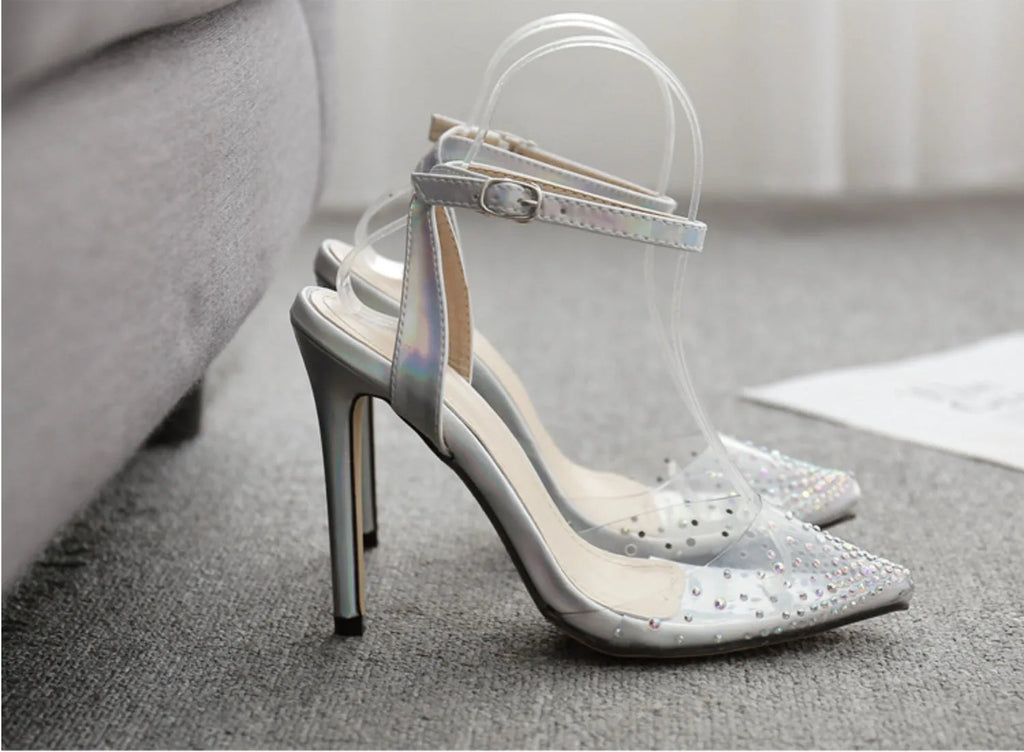 Women's pointed-toe PVC sandals with a stiletto heel on a plain background.