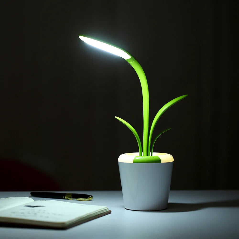 Modern rechargeable desk lamp with plant shape design in pink, showing touch control on a wooden end table