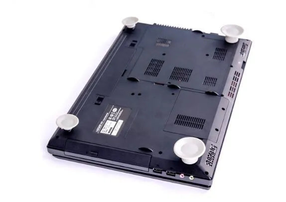 Four grey durable plastic laptop cooling pads, two large and two small, on a wooden desk