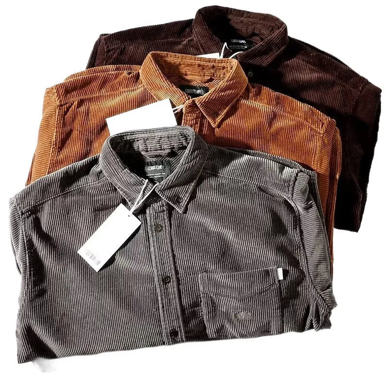 Caramel coloured loose fit corduroy cardigan shirt with long sleeves on a hanger.