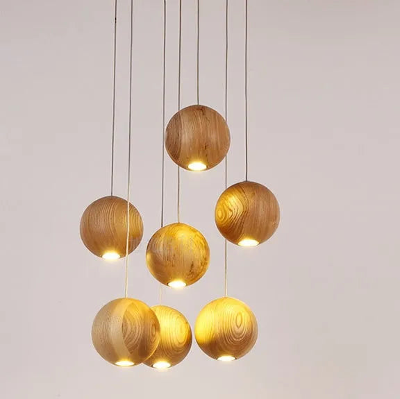 Nordic-style solid wood ball chandelier pendant light with adjustable cord, shown with a wooden disc base.