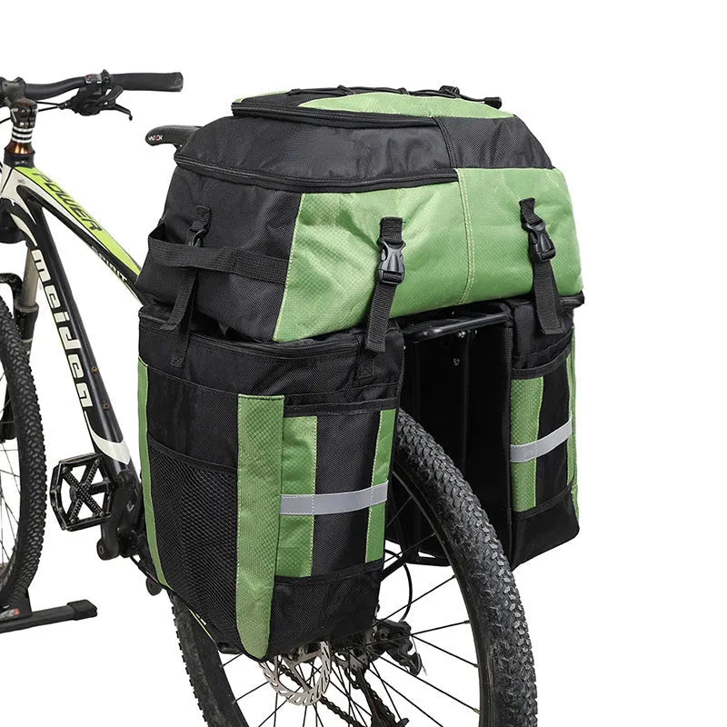 Green 70 litre bicycle rear storage frame bag mounted on a bike for touring.