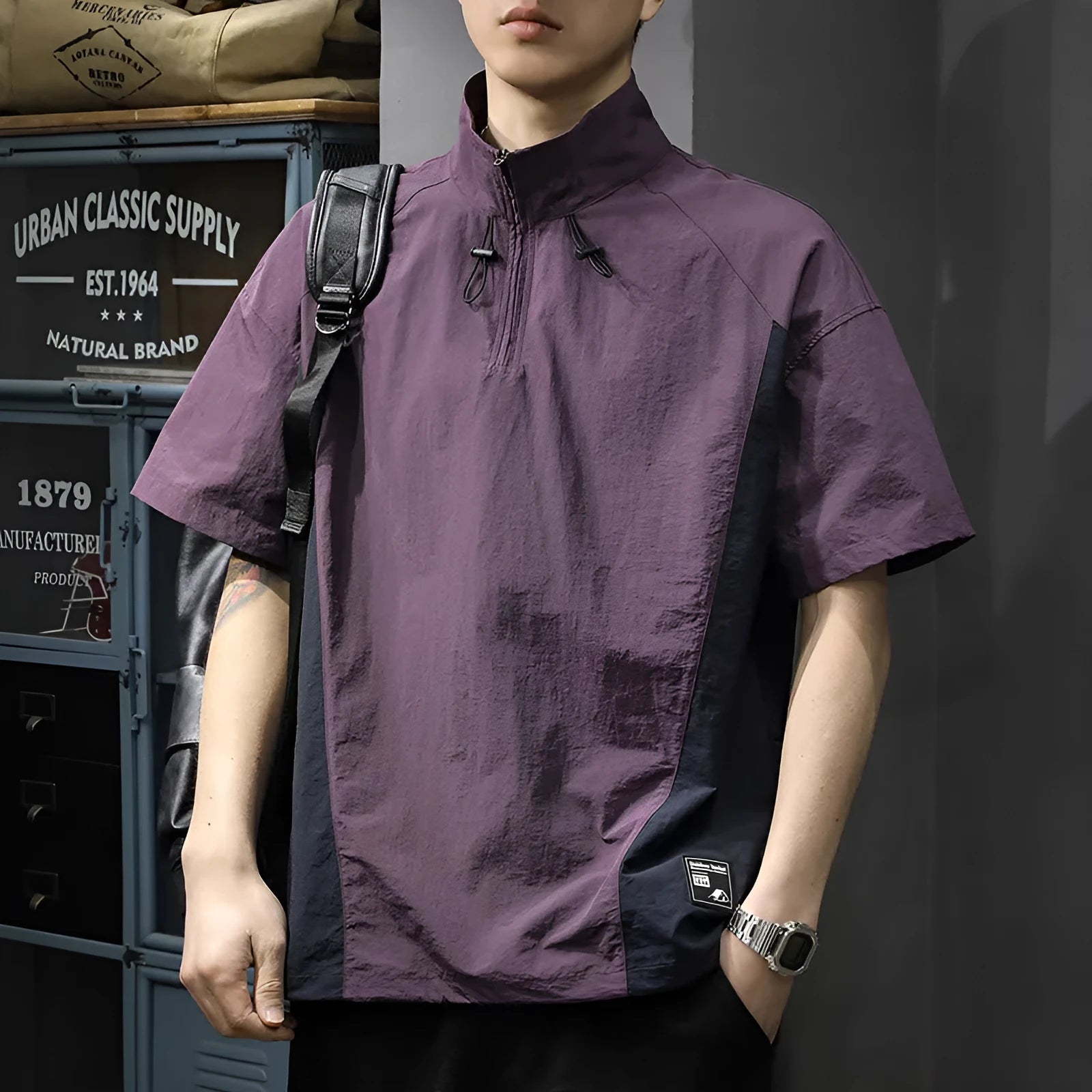 Brown men's half-zip stand collar short sleeve shirt with a fleece-lined interior on a hanger.