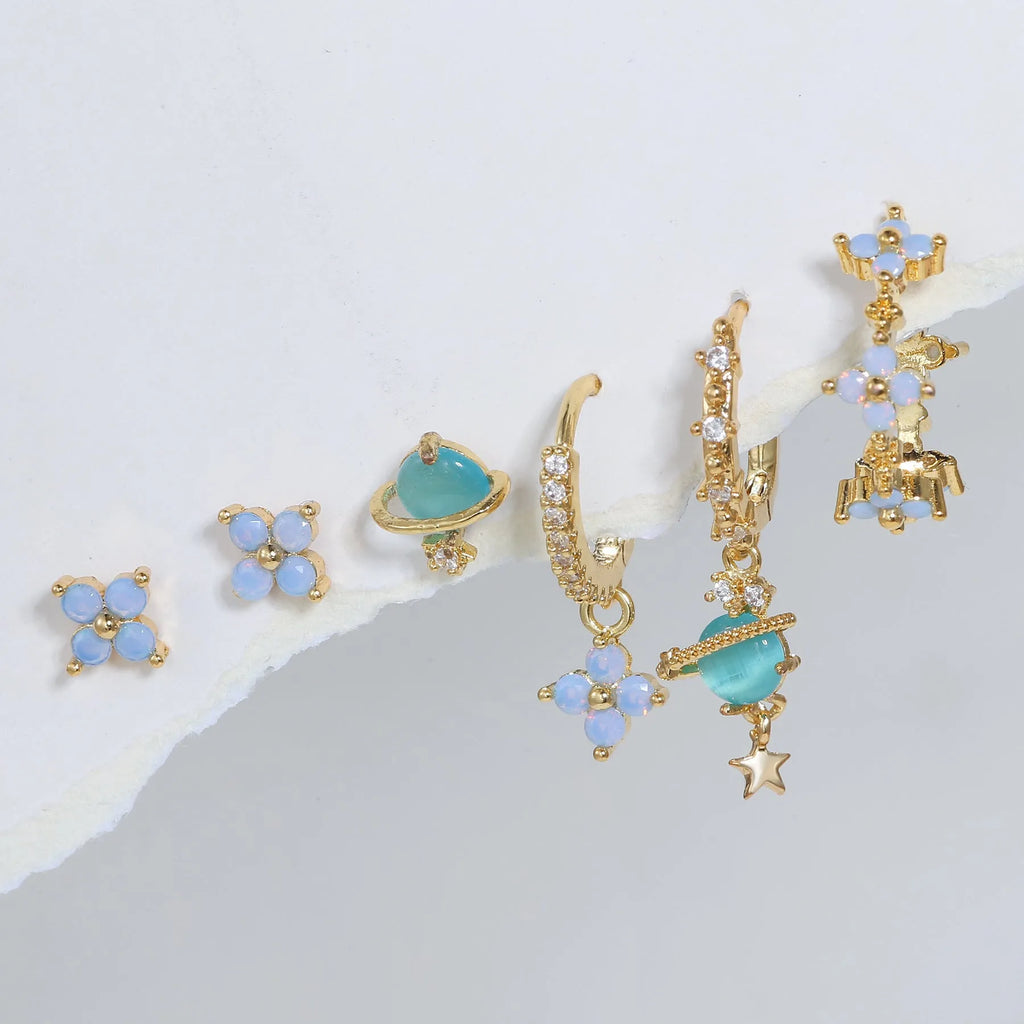 Gold and silver Japanese Korean style ear studs with blue flower nail design and zircon detail