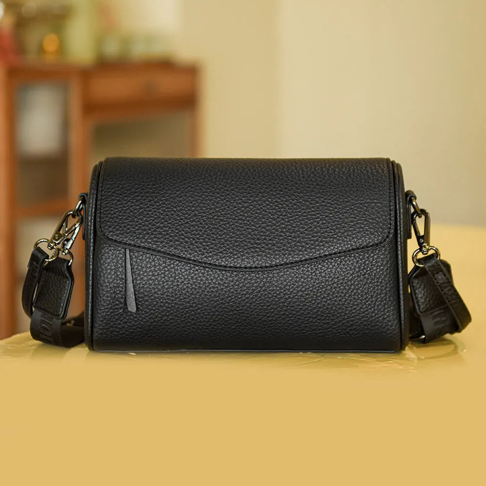 Casual simple women's shoulder messenger bag in black genuine leather with double shoulder straps and lined interior.