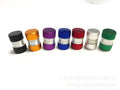 Seven aluminium alloy tyre valve dust caps in black, blue, gold, green, purple, red, and silver on a white background