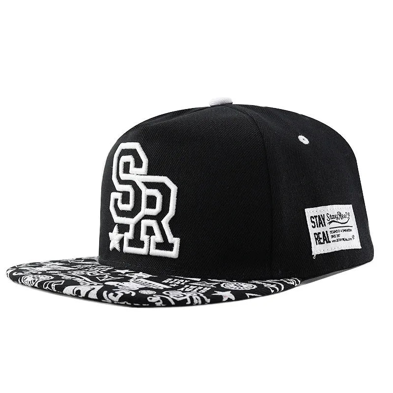 SR Black cotton baseball cap with front letter embroidery, showing adjustable snapback strap and dome crown.