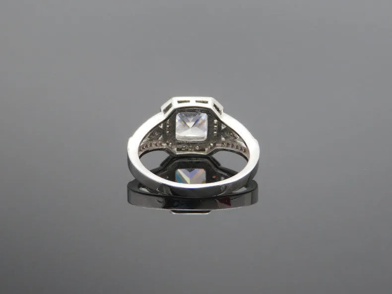 Hollow geometric zircon ring with quadrilateral detailing in platinum colour