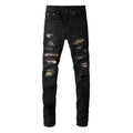 Men's black tattered stretch denim jeans with printed patch on a white background, front view