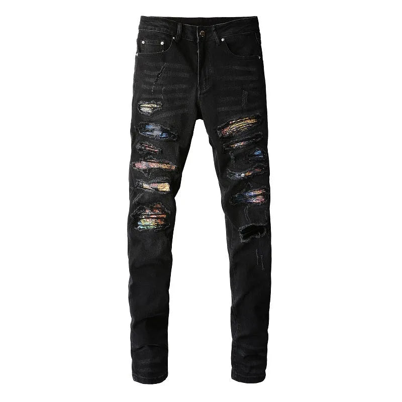 Men's black tattered stretch denim jeans with printed patch on a white background, front view