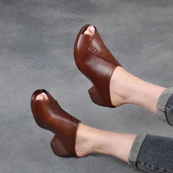 A pair of women's black square heel peep-toe slippers with an open fish mouth design.