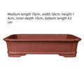 Handmade rectangular purple clay bonsai flowerpot showing its size and thickened ceramic construction.
