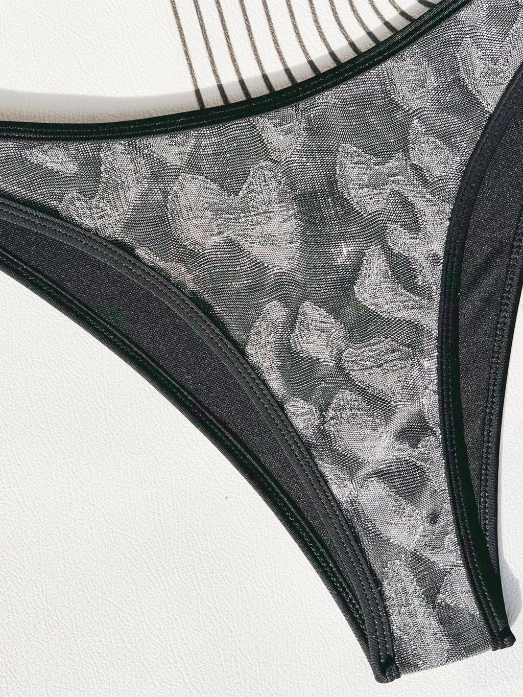 Black women's bikini swimsuit with adjustable straps on a mannequin.