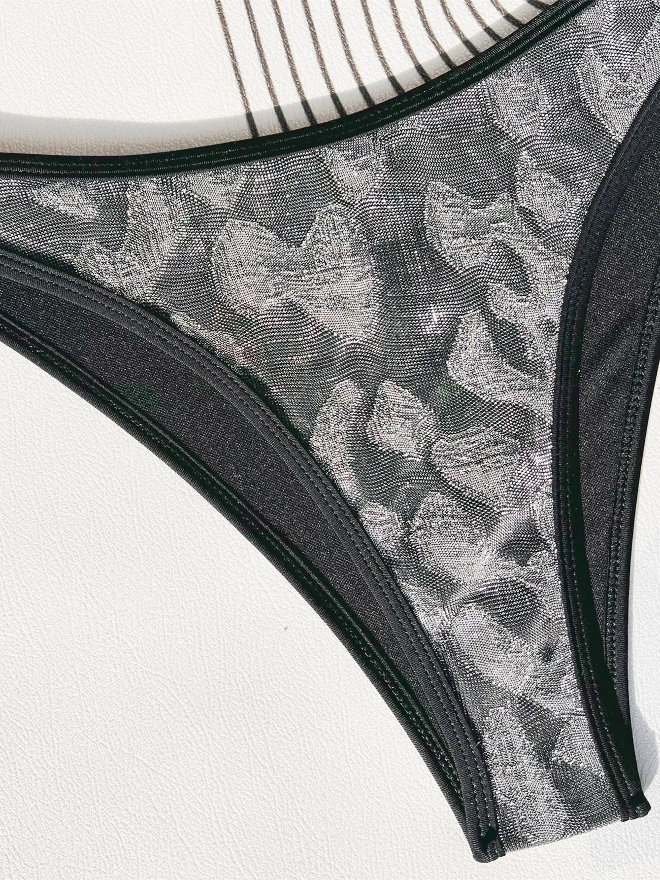 Black women's bikini swimsuit with adjustable straps on a mannequin.