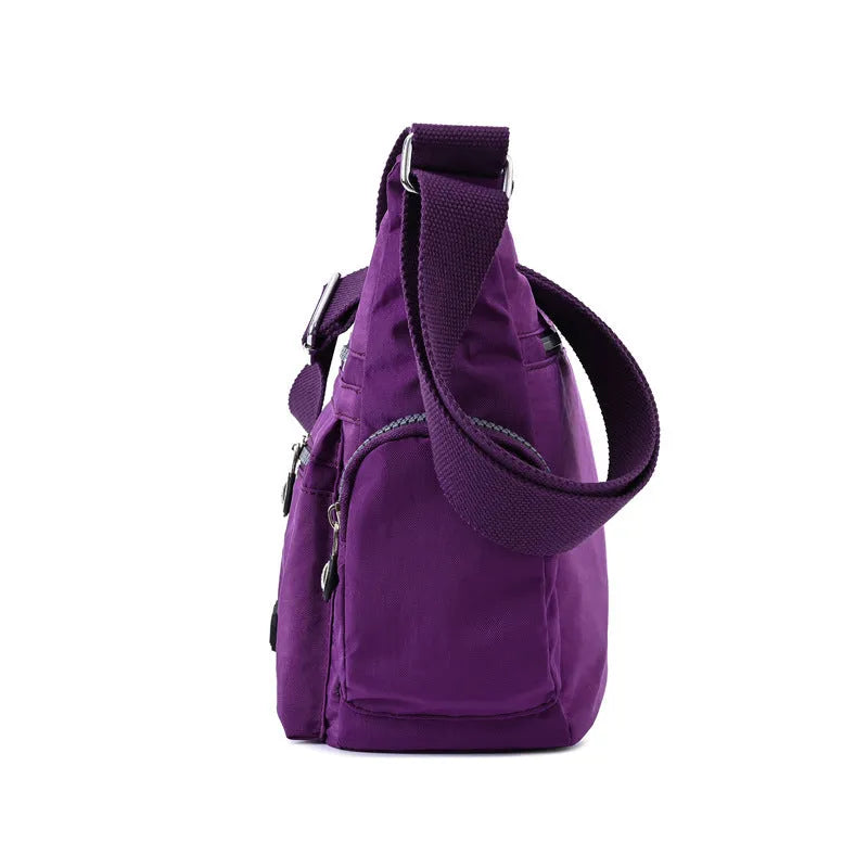 Women's waterproof nylon crossbody shoulder bag in black with multiple pockets and telescopic handle