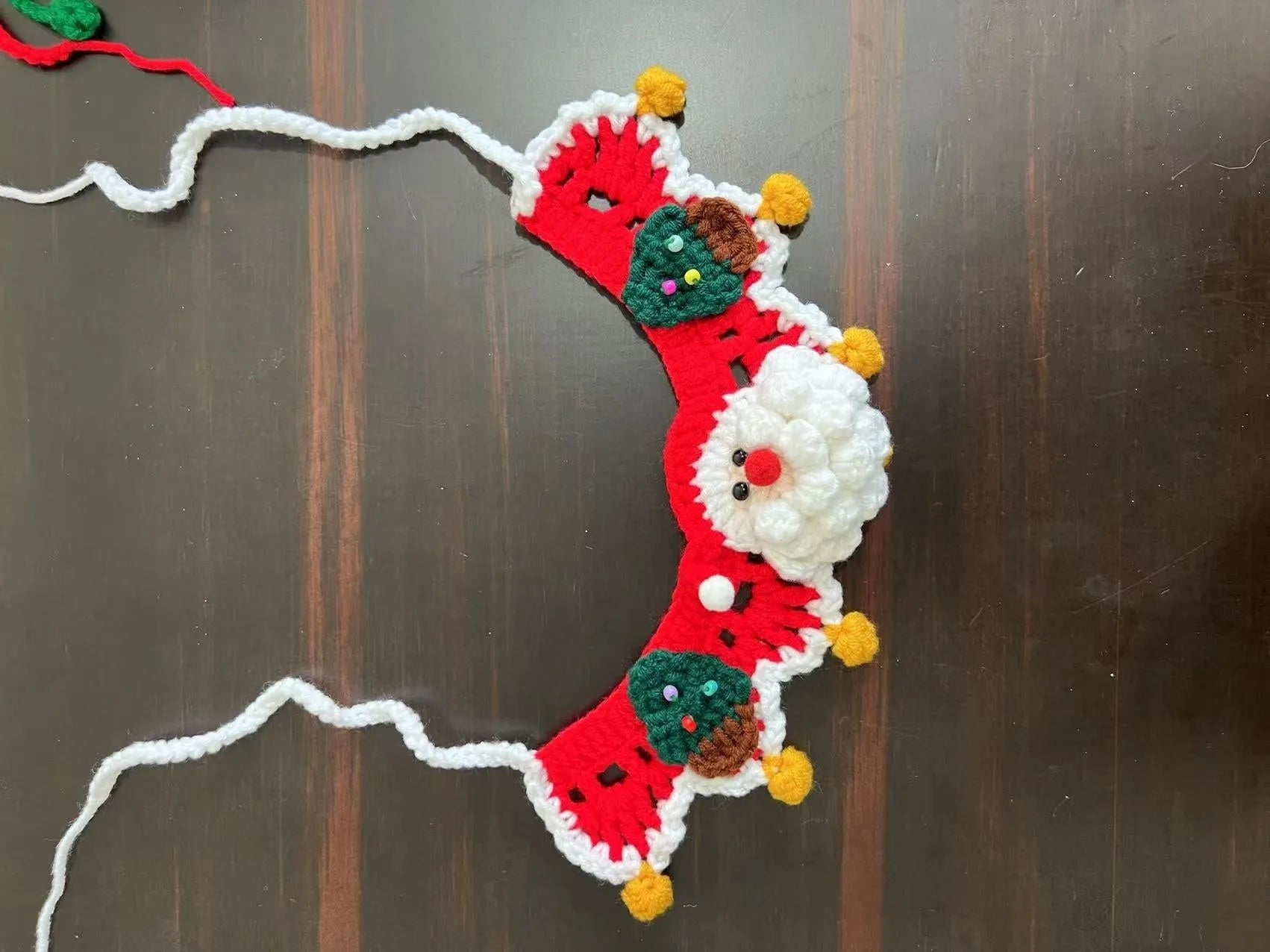 Knitted wool Christmas pet scarf with Santa Claus pattern for dogs and cats in holiday red and green colours