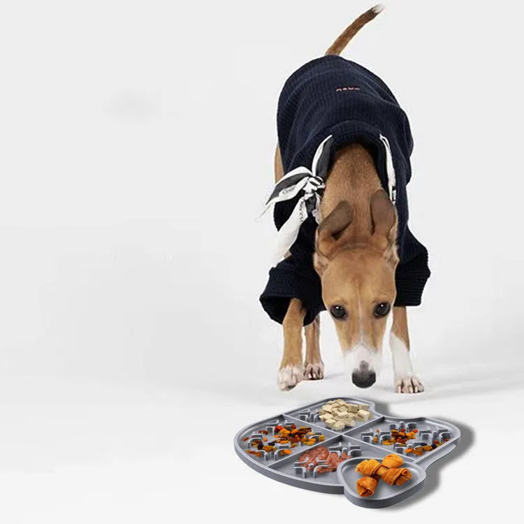 Gray silicone pet slow food pad with suction cups on tile floor, textured surface for licking