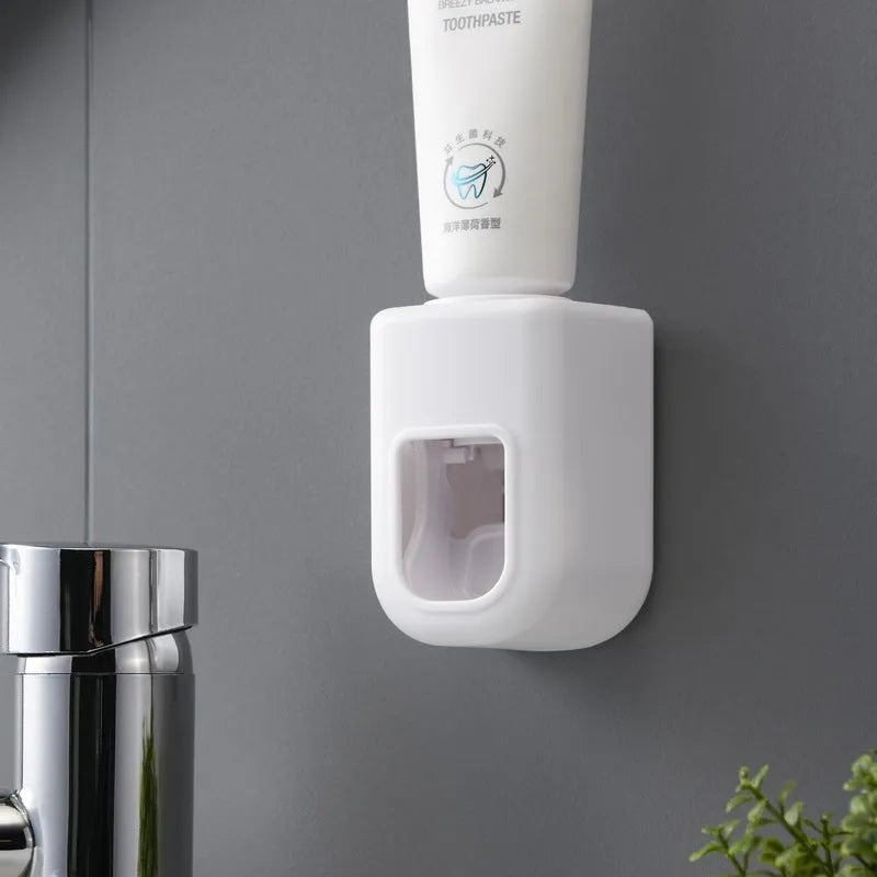 Nordic automatic toothpaste dispenser wall mounted in pink colour with compact 9x6x6cm design
