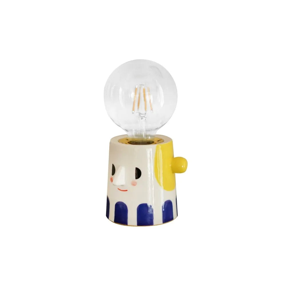 Handmade ceramic table lamp with a white spherical shade on a solid ceramic base, showcasing its simple design.