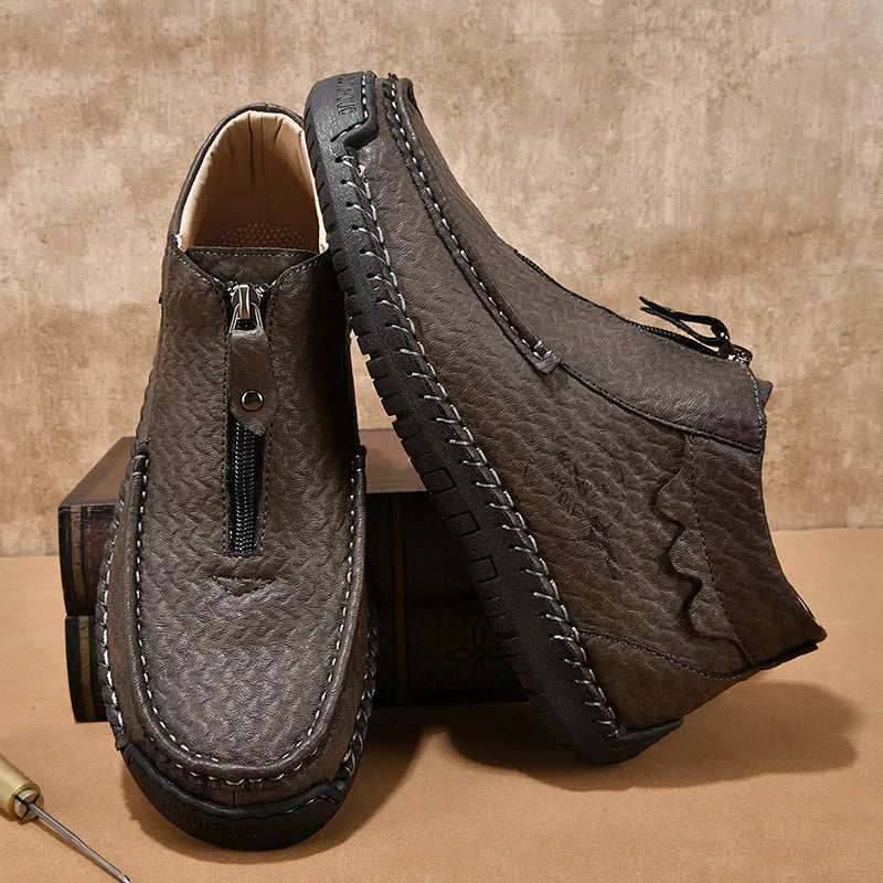 Men's black slip-on loafers with a round toe and low rubber sole.