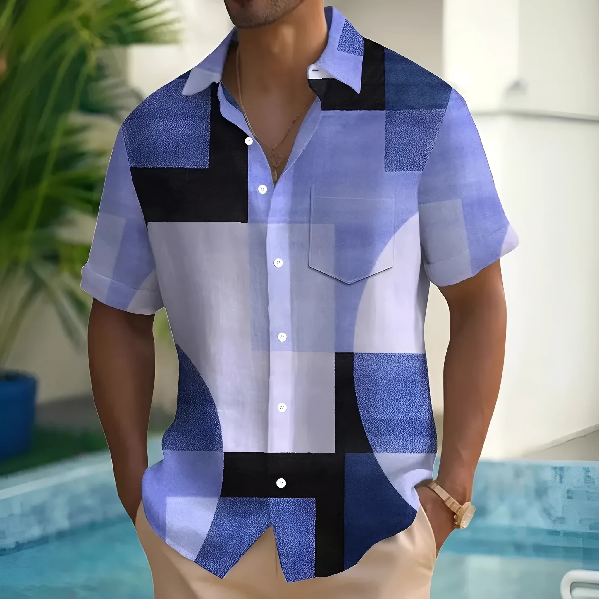 Man wearing a loose-fit short sleeve cardigan shirt with a blue and white geometric 3D print pattern.