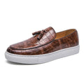 Men's black slip-on sneakers with a decorative tassel and round toe on a rubber sole.