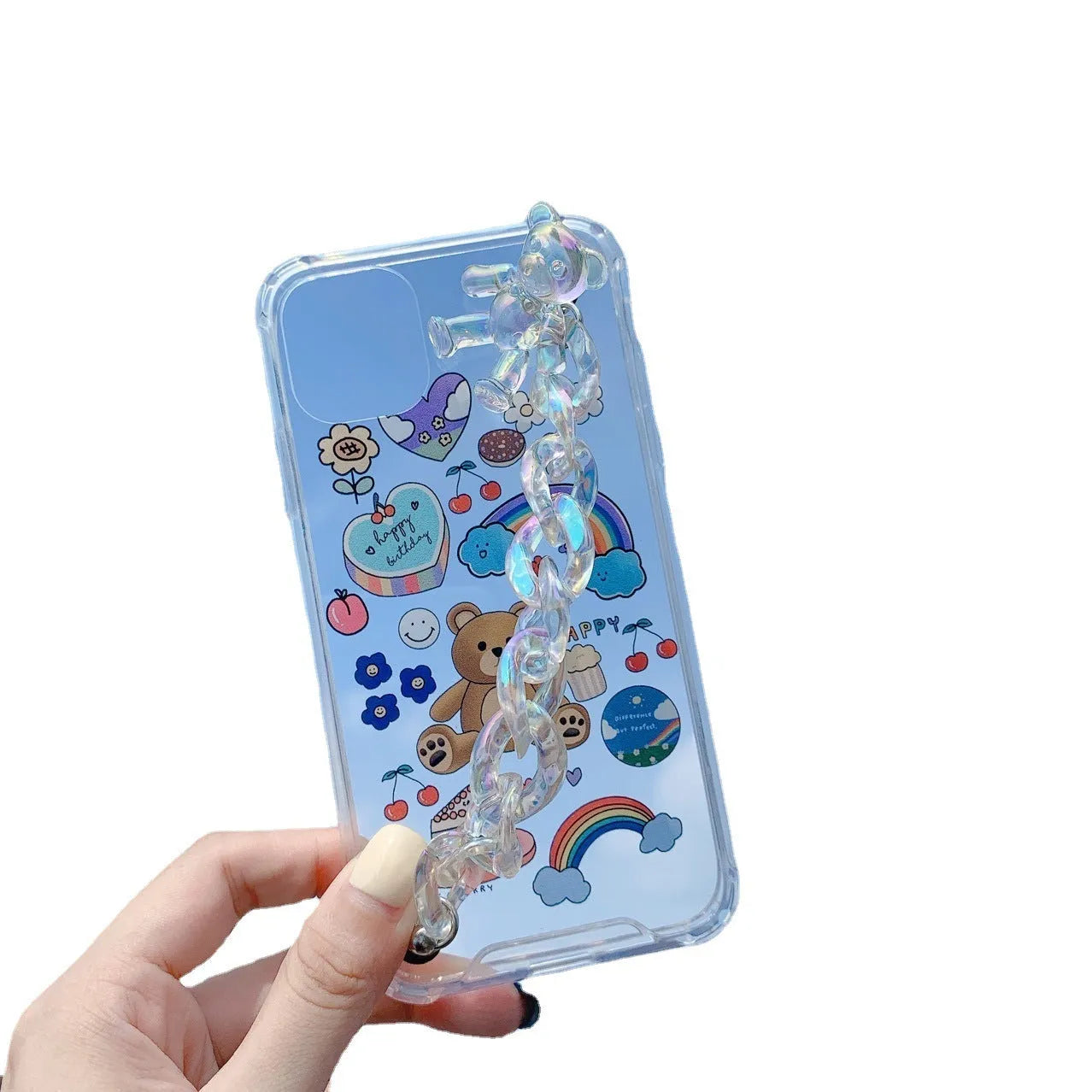White iPhone case with a cartoon bear design and a connected silver bear pendant on a chain.