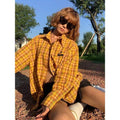 Yellow and white plaid shirt with a loose cardigan fit on a hanger.