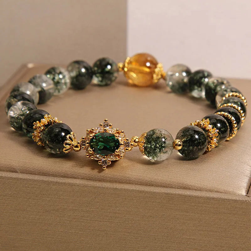 Women's green phantom quartz crystal bracelet with gold rutile needle inclusions and rhinestone accents