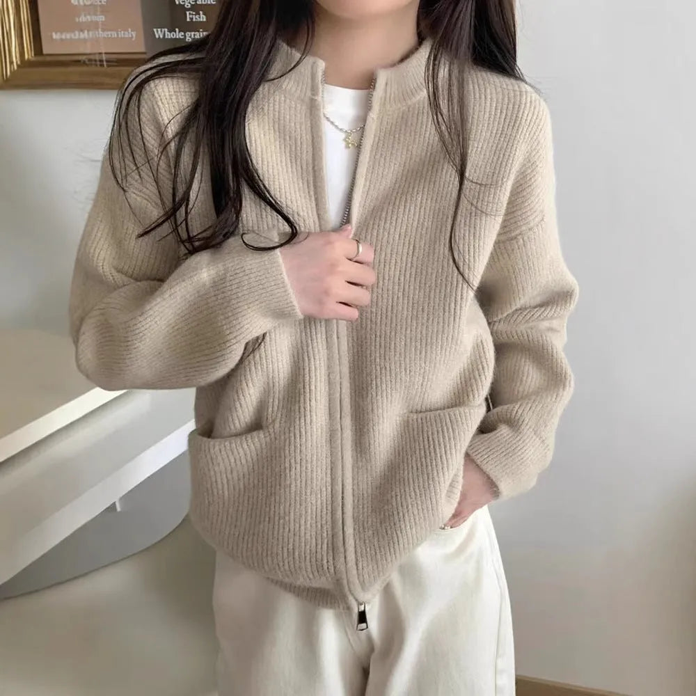 Beige viscose knit sweater coat cardigan with long sleeves laid flat.
