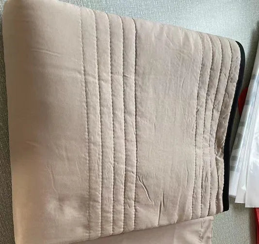 Lightweight seersucker summer quilt in various colours on a bed