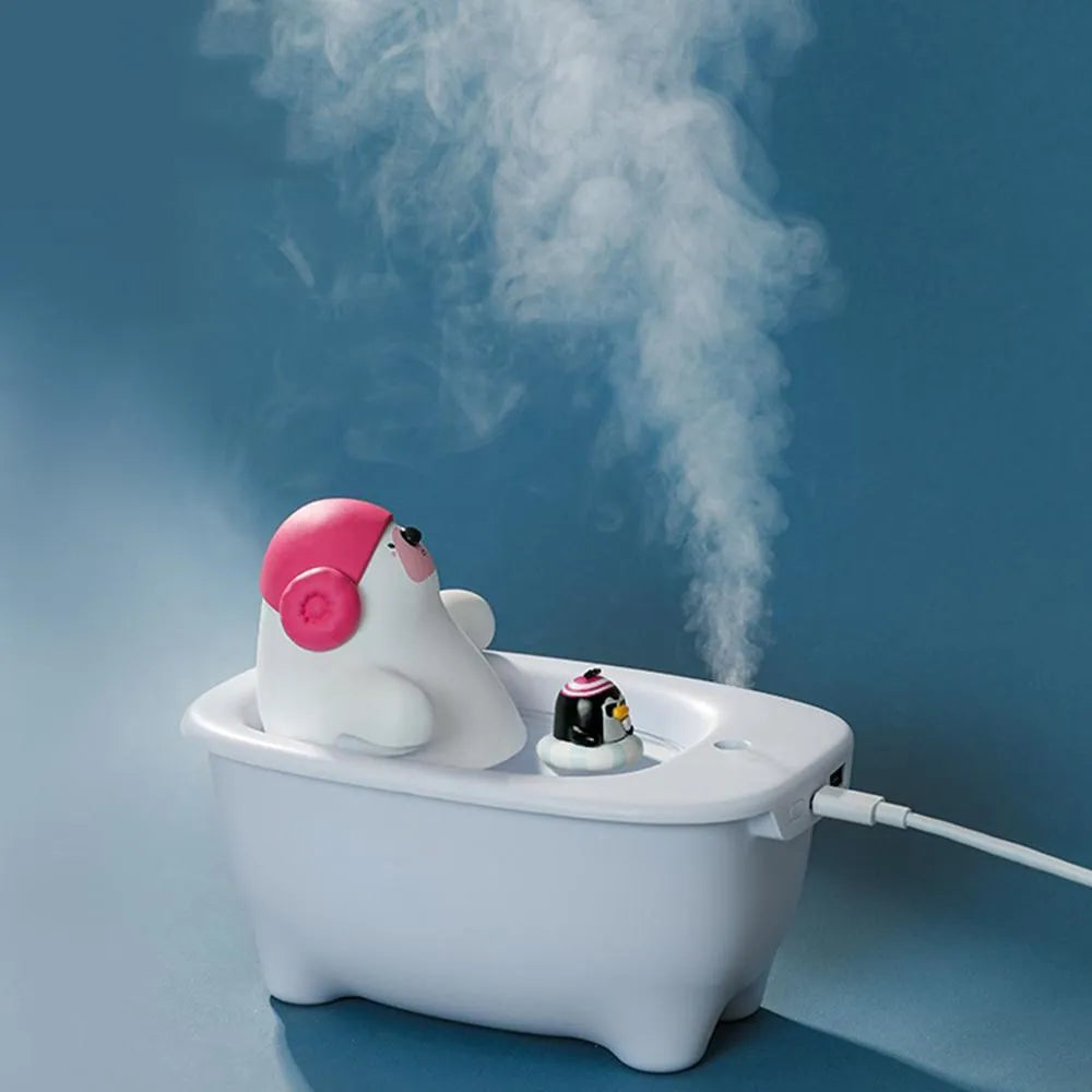 White plastic USB air humidifier with water tank on a desk