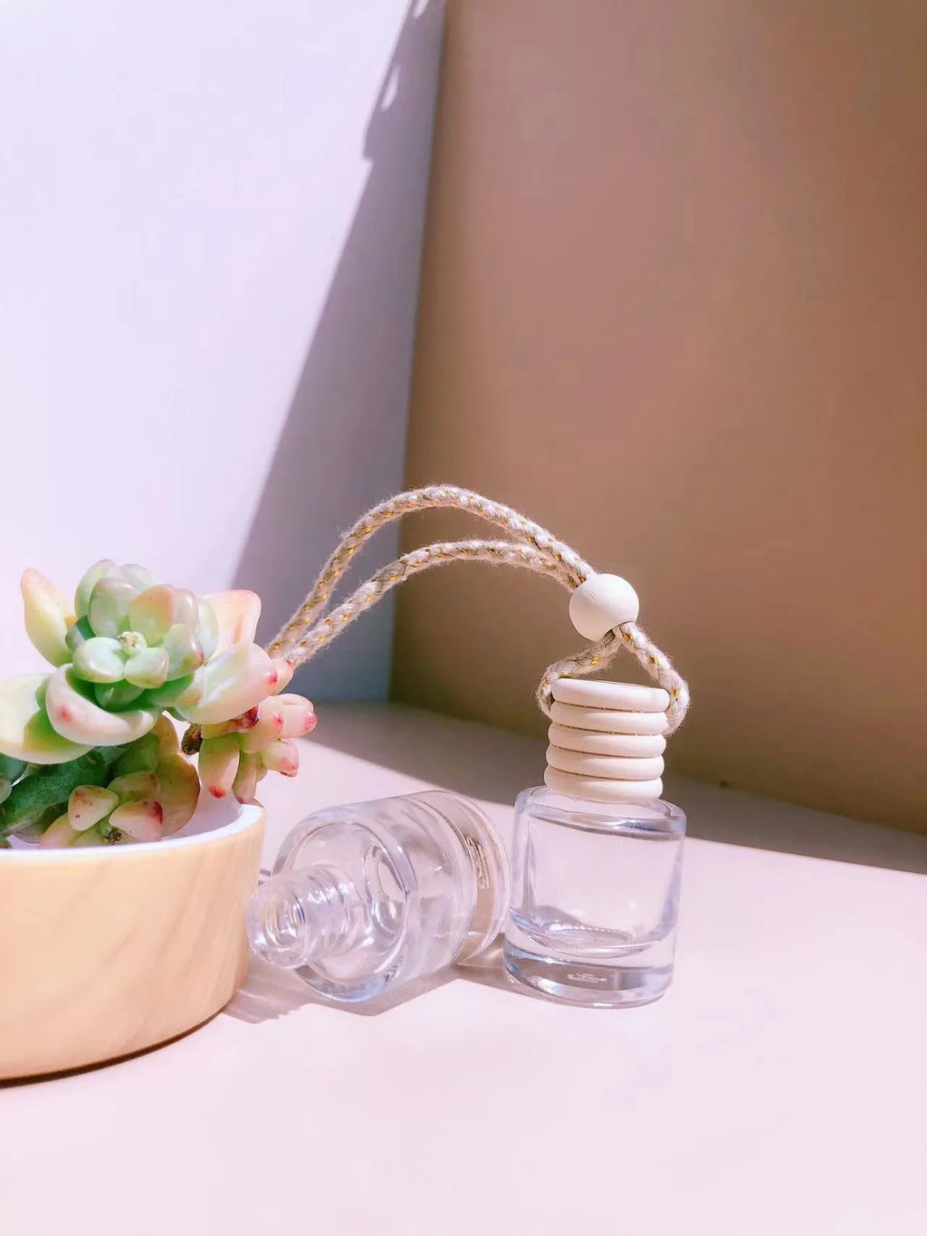 Car air vent perfume pendant showing cylinder, diamond, flat drum, and square glass bottle designs