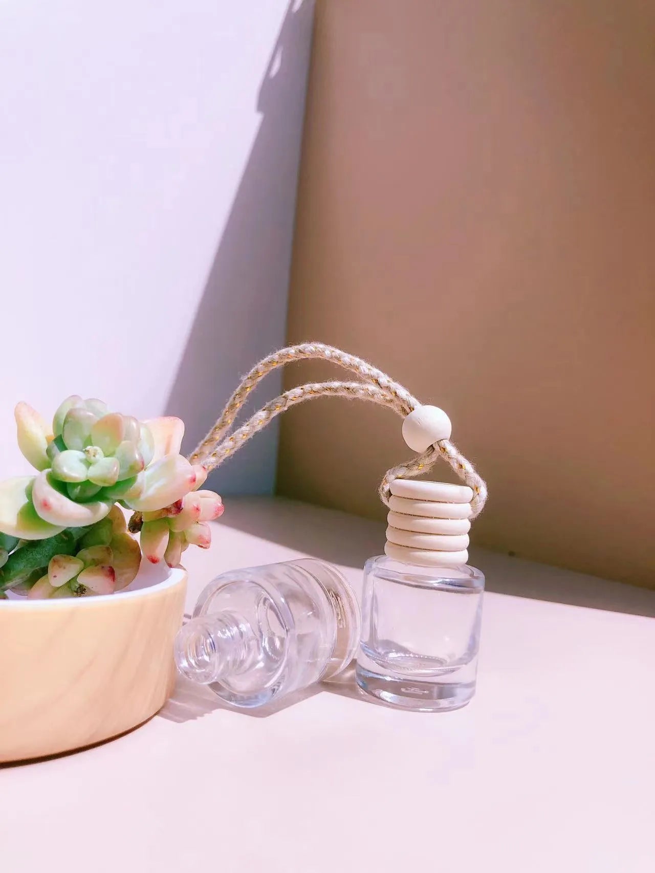 Car air vent perfume pendant showing cylinder, diamond, flat drum, and square glass bottle designs