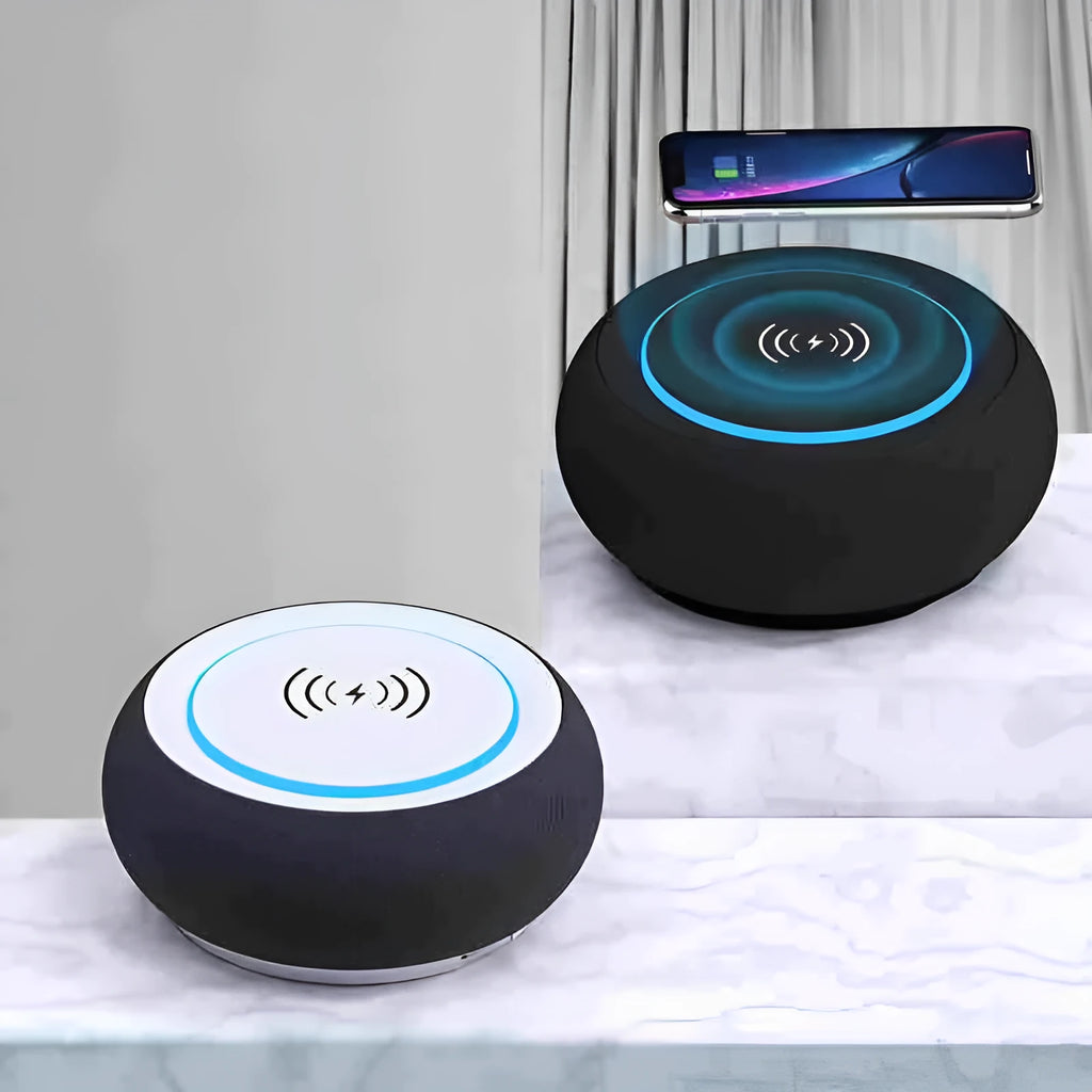 Black wireless Bluetooth speaker with dual speakers and subwoofer on a wooden table