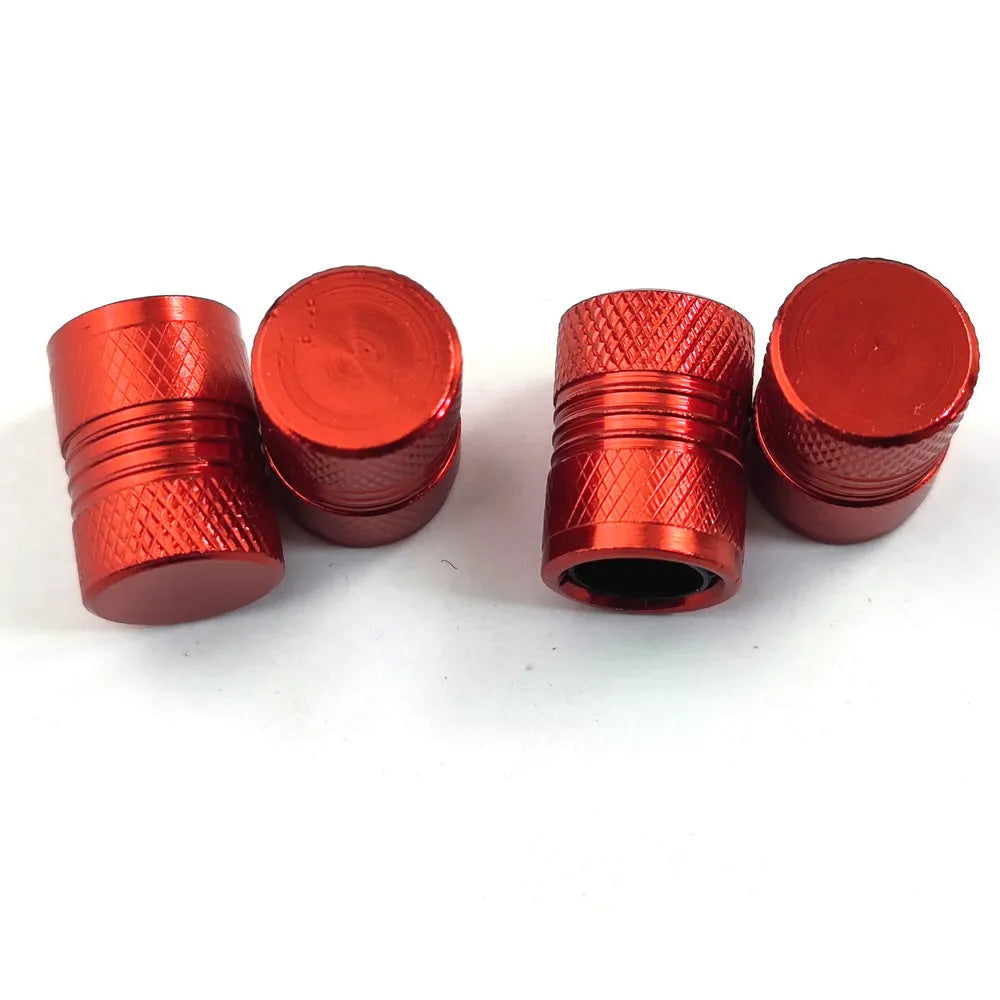 Aluminium car tyre valve dust cap in four colour options: black, blue, grey, and red.