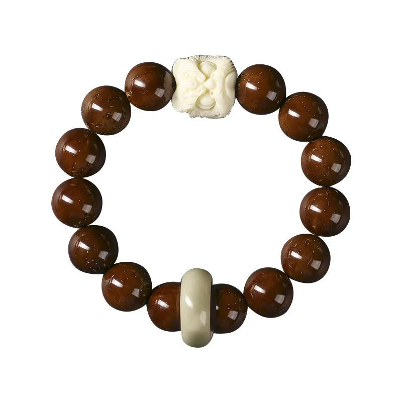 Hand-woven bracelet with 13mm round beads showing lion design in ivory nut, bodhi or sandalwood style
