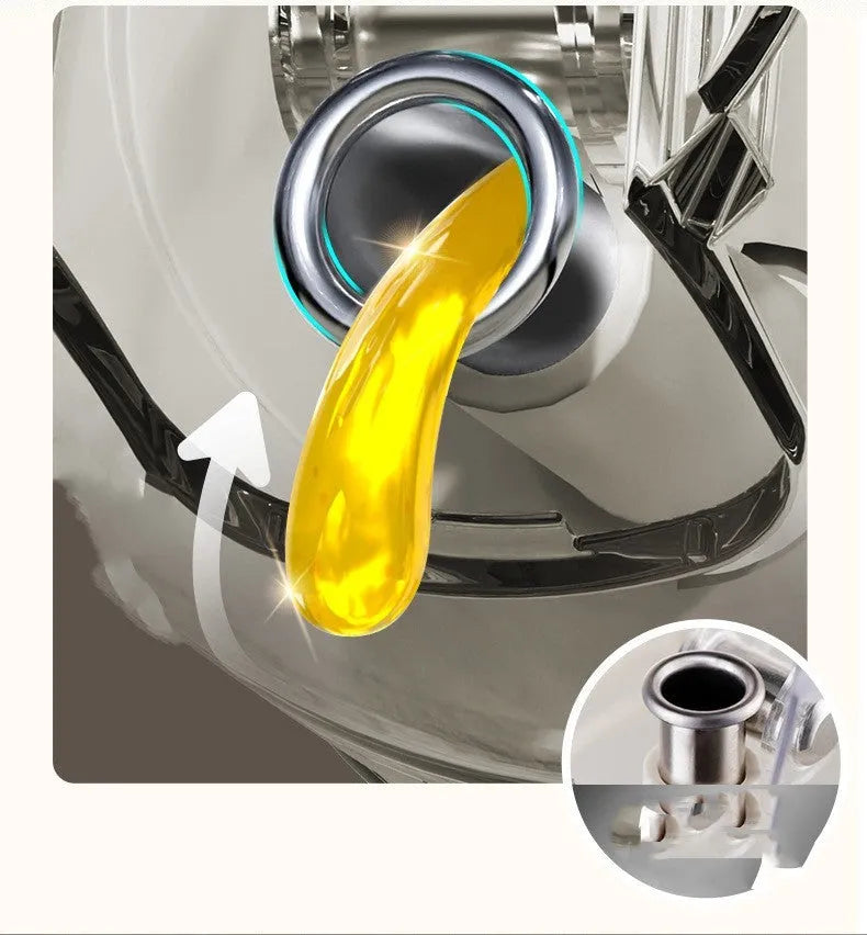 Warm grey glass oil sprayer bottle with a dual-mode cap switch, shown on a kitchen counter.